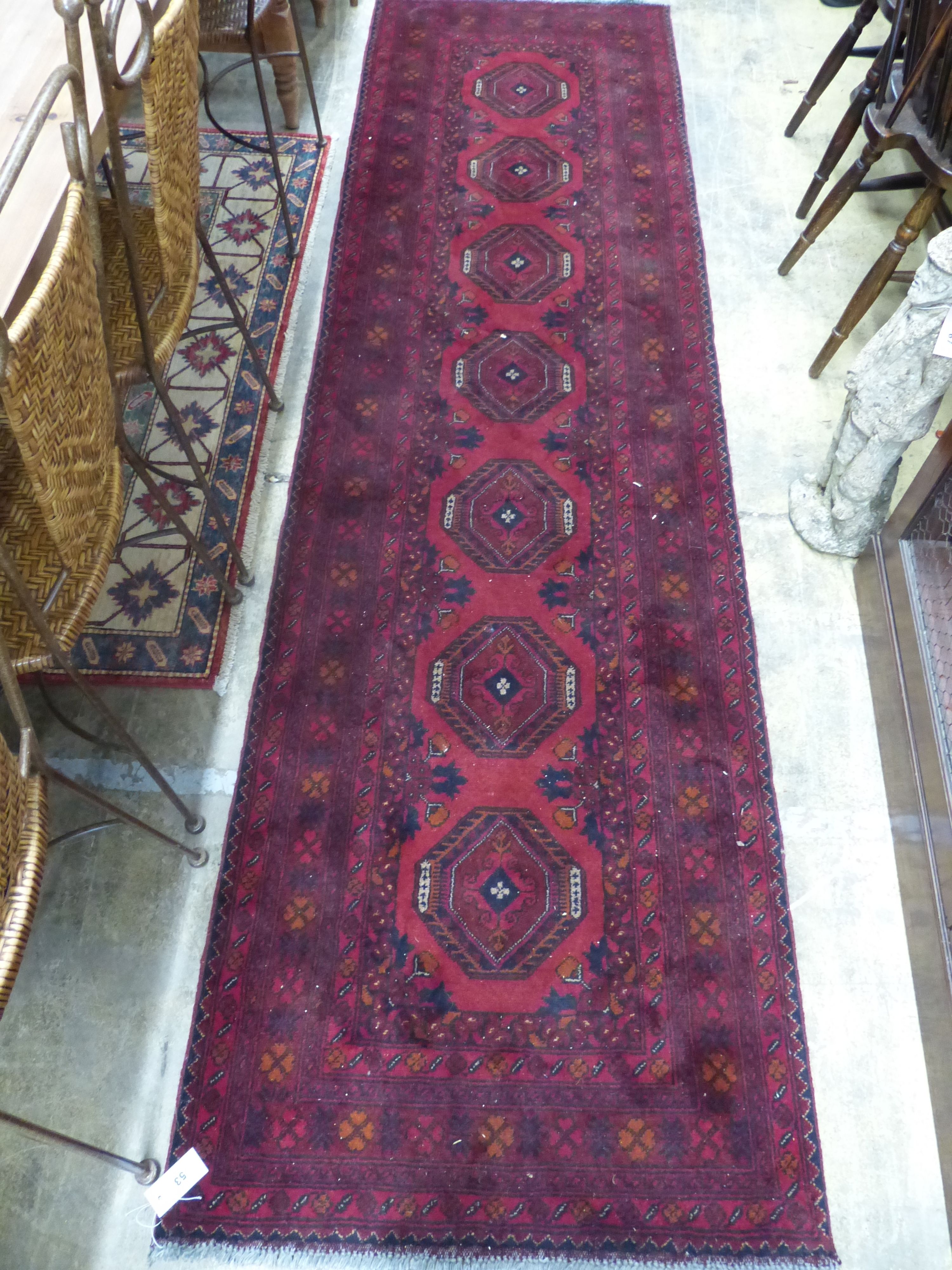 A Bokhara red ground runner, 290 x 82cm